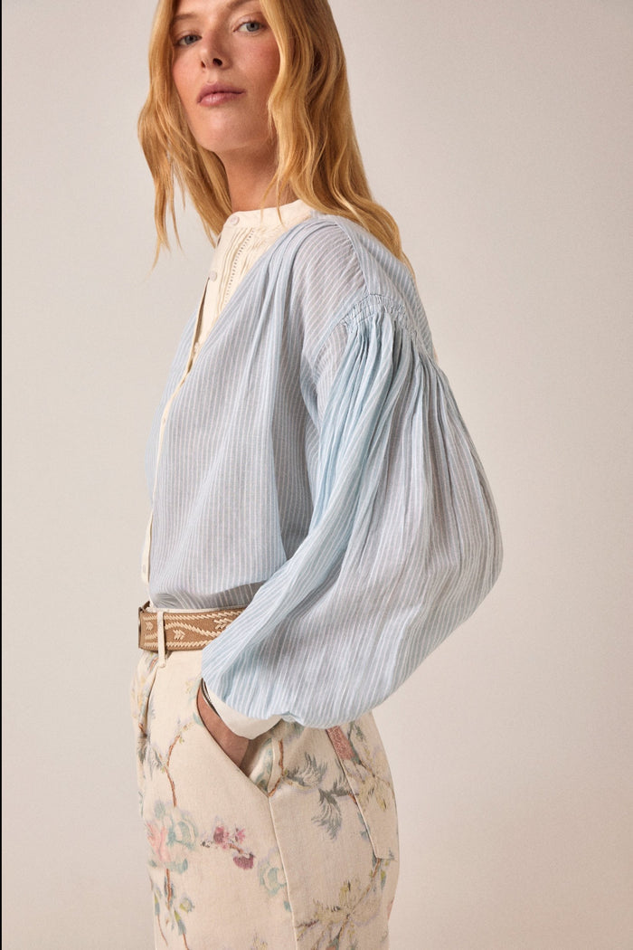 ELSHAM BOUTIQUE Bonifacio shirt in light blue pinstriped cotton with cream embroidered yoke and balloon sleeves.