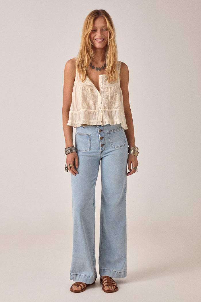 ELSHAM BOUTIQUE ivory cotton Constanza top with lace panel, thin straps, and drawstring waist worn with light jeans.