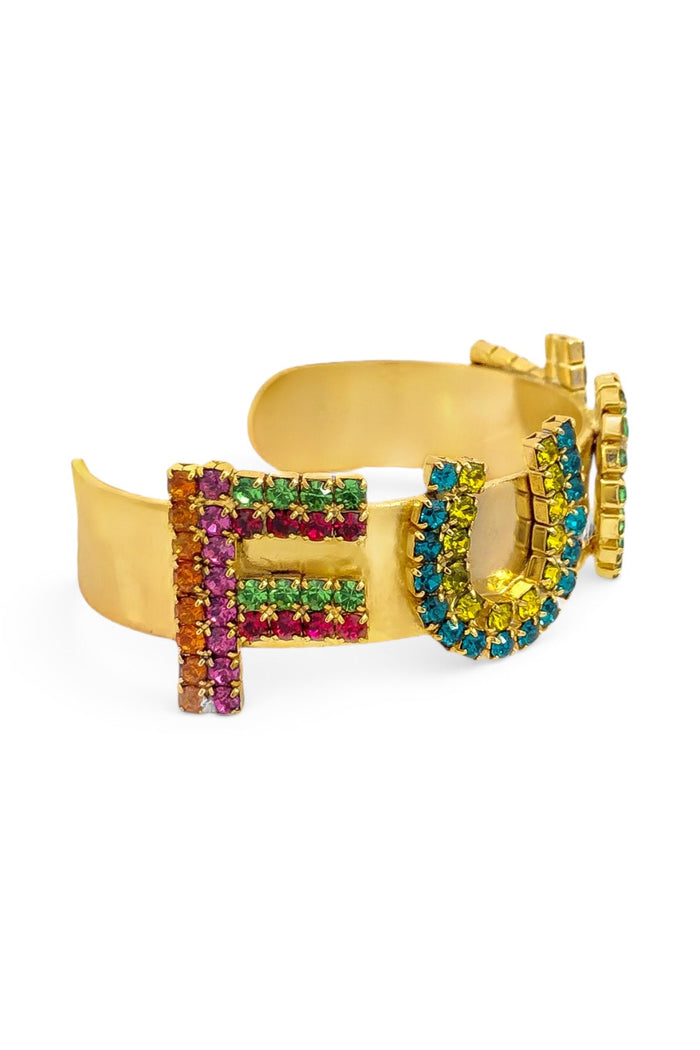 ELSHAM BOUTIQUE antique gold plated brass cuff bracelet featuring colorful crystal-encrusted letters on a white background