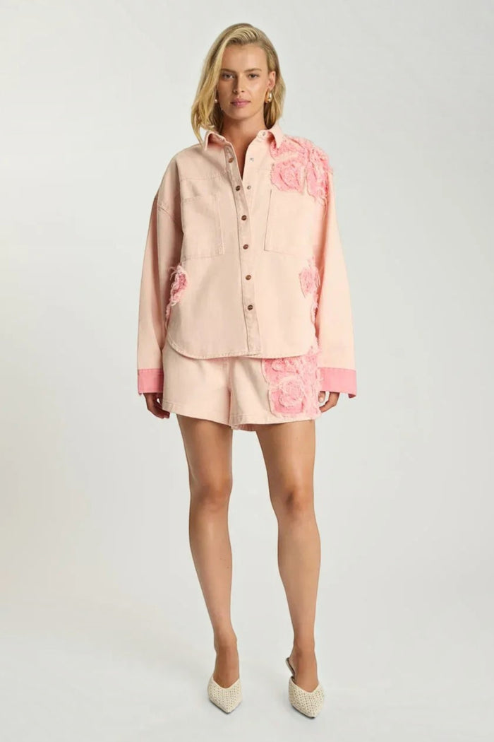 Model wearing ELSHAM BOUTIQUE pink petal oversized cotton denim shacket with frayed edges and matching denim shorts