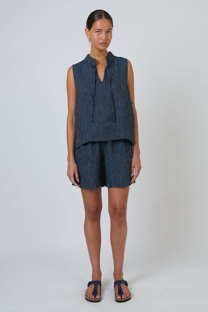 ELSHAM BOUTIQUE navy pinstripe linen sleeveless top with V-neck and drawstring tie worn with matching shorts