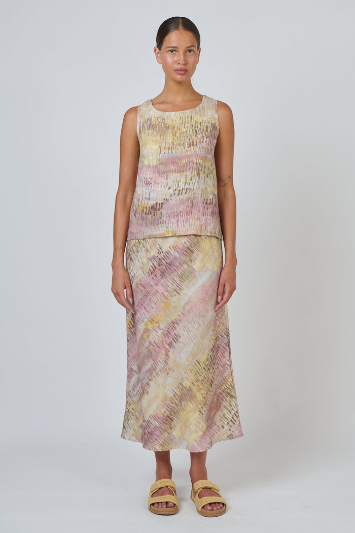 ELSHAM BOUTIQUE Jardin sleeveless linen top with high-low hem and matching skirt in a pink and yellow abstract print.