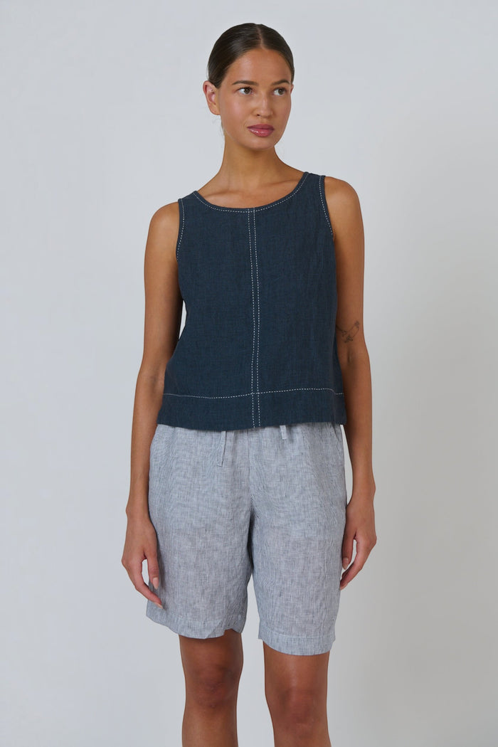 ELSHAM BOUTIQUE sleeveless linen top in gunsmoke grey with white contrast stitching and a relaxed fit on a model.