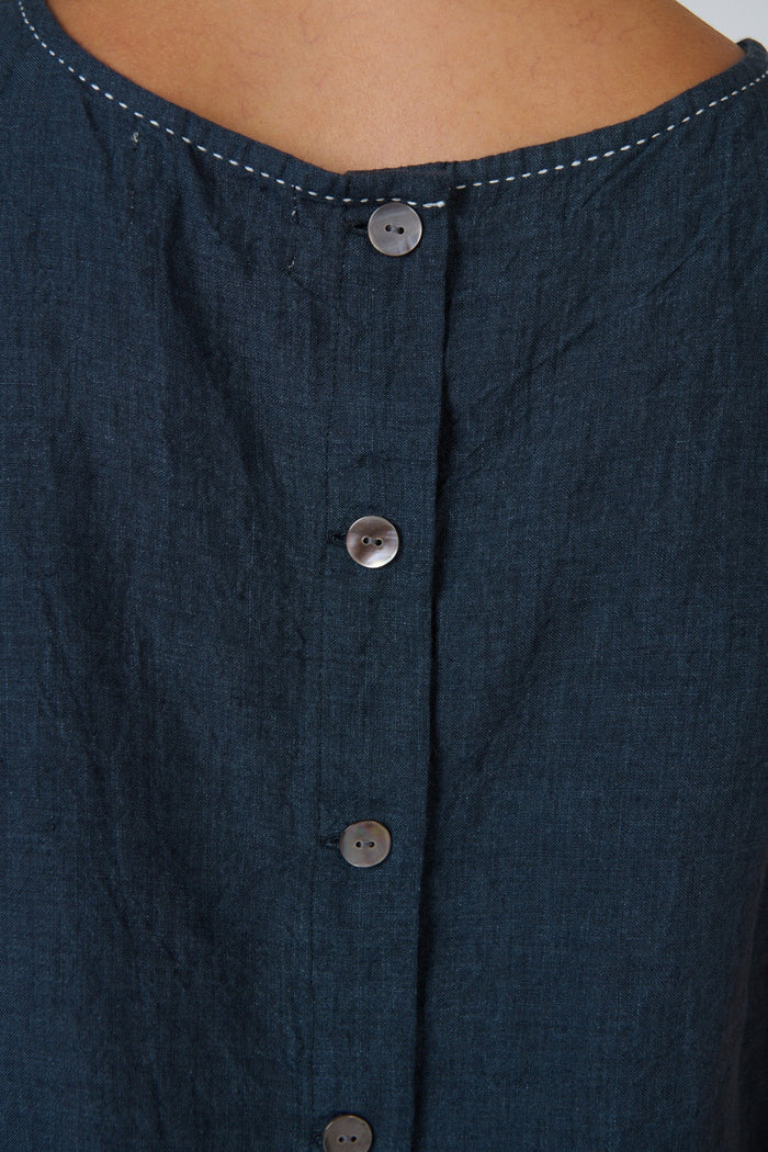 ELSHAM BOUTIQUE sleeveless linen top in gunsmoke grey featuring a round neckline and back button closure detail.