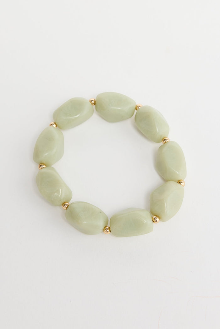 ELSHAM BOUTIQUE Havana stretch bracelet featuring pale green resin beads and small gold-tone metal accents.