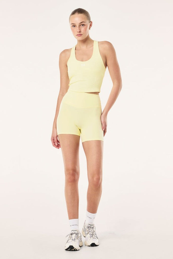 ELSHAM BOUTIQUE soft yellow ribbed racerback tank top with internal shelf bra worn with matching athletic shorts
