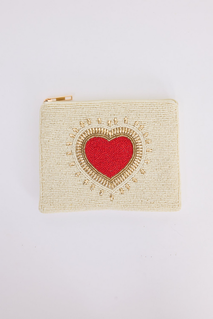 ELSHAM BOUTIQUE cream beaded zip clutch with a red and gold embellished sacred heart motif.