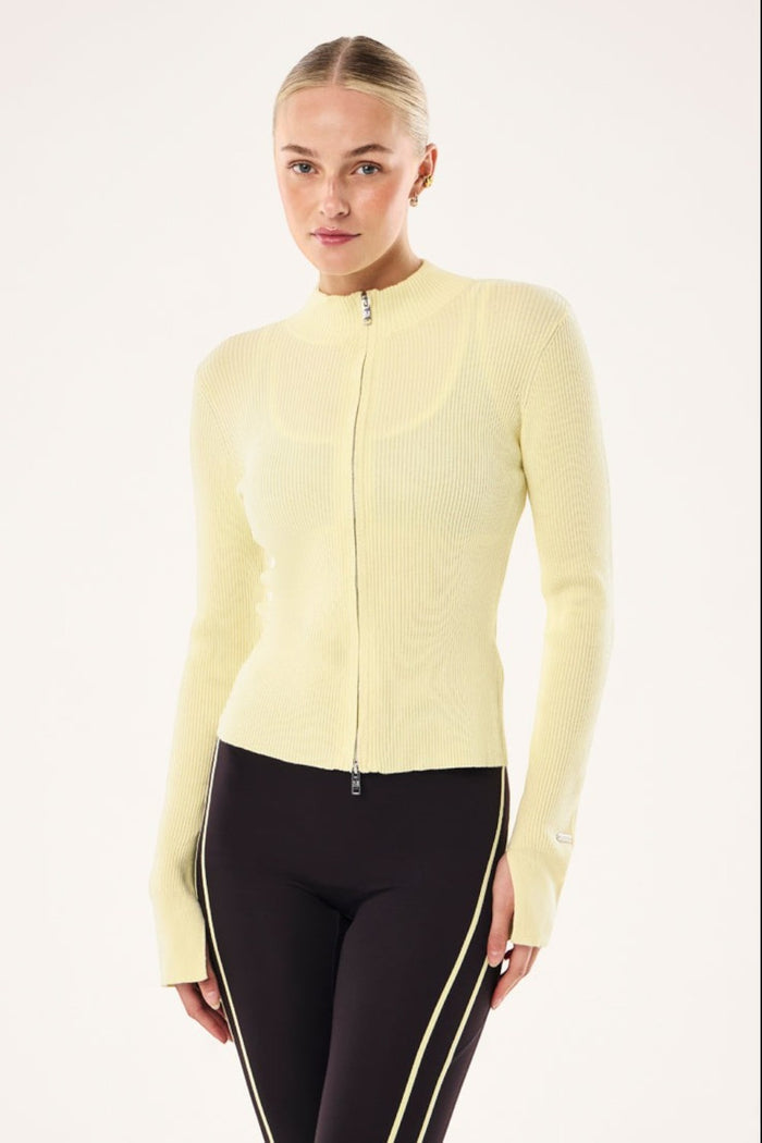 ELSHAM BOUTIQUE soft yellow rib knit zip-up jacket with high neck and long sleeves worn by a model