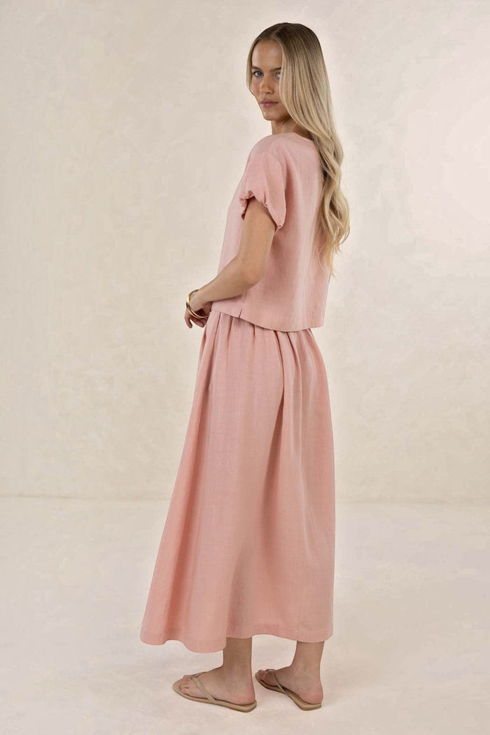 ELSHAM BOUTIQUE Solar Skirt in musk pink linen-tencel blend, featuring an A-line midi silhouette and side pockets.