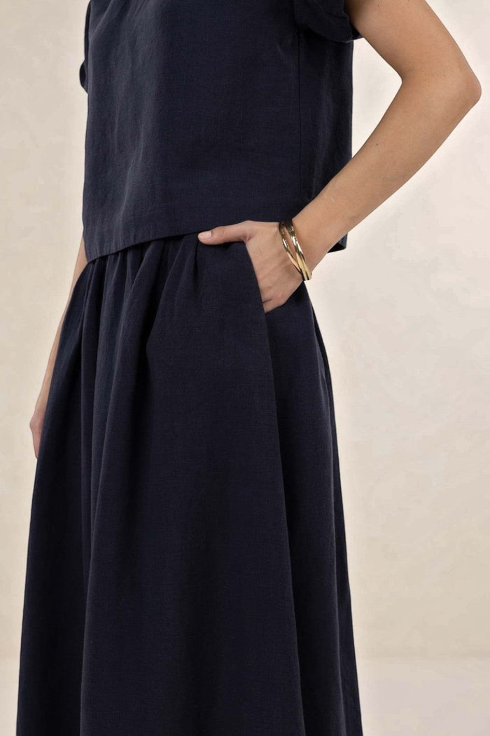 ELSHAM BOUTIQUE navy linen-tencel midi skirt with gathered A-line silhouette and functional side pockets