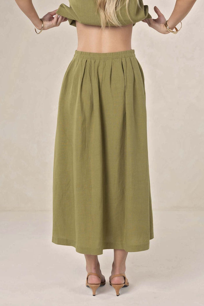 ELSHAM BOUTIQUE olive green linen-tencel midi skirt with an A-line silhouette and elasticated waist, back view.
