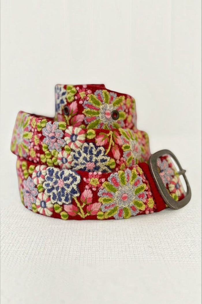 ELSHAM BOUTIQUE red wool belt featuring intricate multi-colored floral embroidery and a lead-free metal buckle.