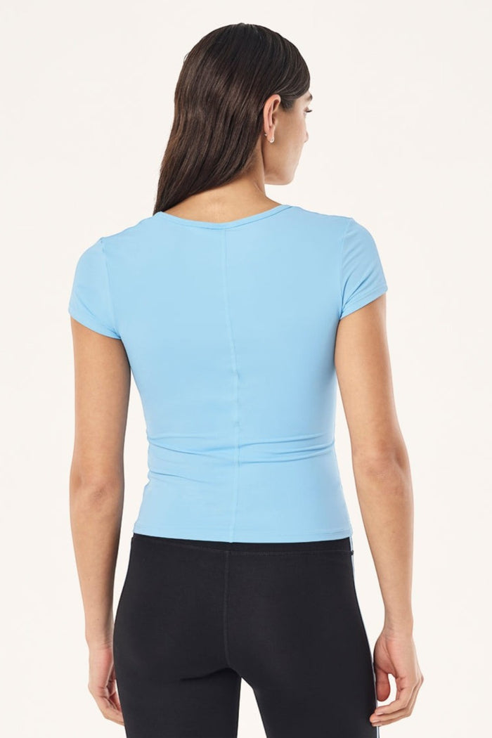 Back view of ELSHAM BOUTIQUE Alaskan Blue scoop neck short sleeve top in soft Body Luxe fabric on a model